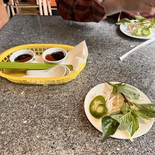 a person sitting at a table with plates of food