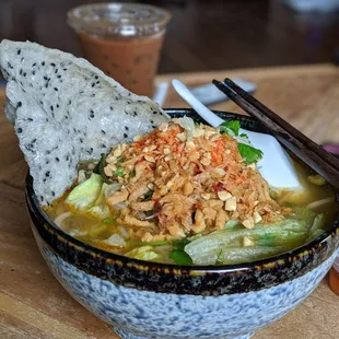 a bowl of food with chopsticks