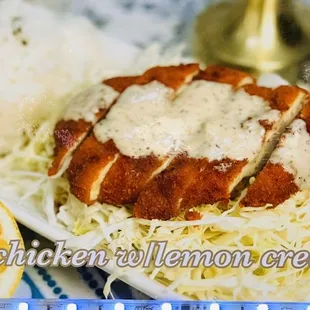 a plate of chicken with lemon cream sauce