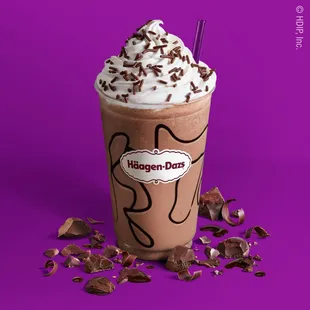 a milkshake with whipped cream and chocolate sprinkles
