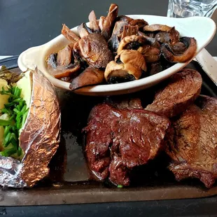Half order of "Tenderloin for Two" wuth a baked potato and additional side of sautéed mushrooms
