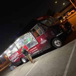 a man standing in front of a food truck