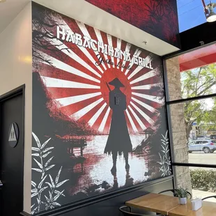 a wall mural of a man holding a sword