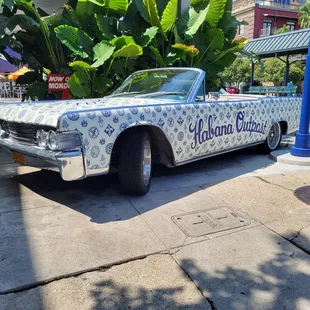 a white car with blue flowers on it