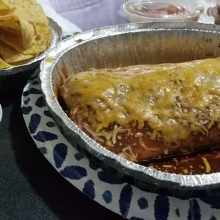 Chips, quac, and burrito! Green chili pork, rice and beans.