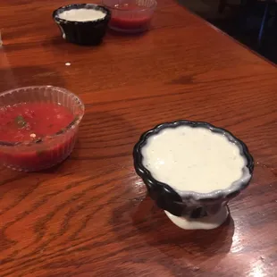 Salsa and some kind of white sauce that comes to the tables with chips.