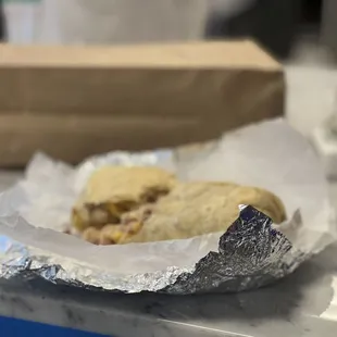 Bacon, egg, bean, potato and cheese burrito.