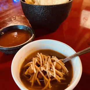 a bowl of soup and chips
