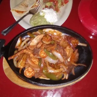 From Habaneros Fresh Mex: fajitas supreme featuring beef, chicken, and shrimp. So good!