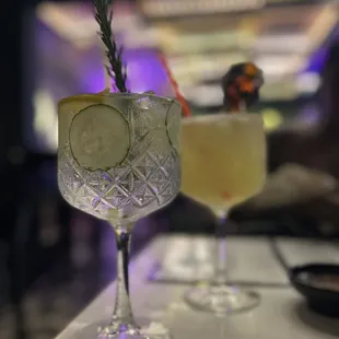 two cocktails on a bar