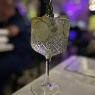 a gin cocktail with cucumber and rosemary