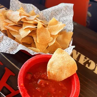 a bowl of salsa and chips