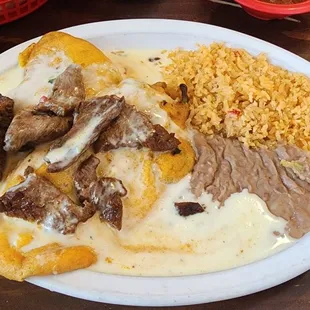 Chili Rellenos are cheese filled and dipped in a light and fluffy corn meal batter before being deep-fried.  These are served with beef.