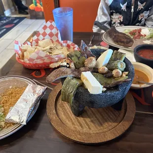 My husband&apos;s dinner, in mortar, plus all the sides.  I ordered the Steak Americana.  Yum!!