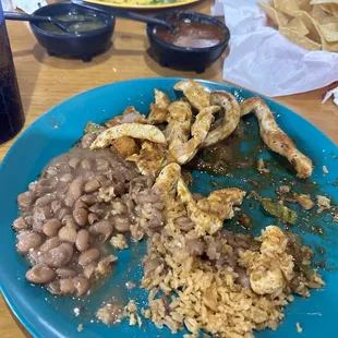 Chickrn cut into strips, rice and refried Beans salsa on the side.