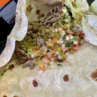 Carne asada burrito with green salsa
