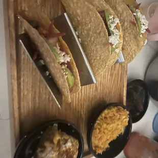 a variety of tacos on a cutting board