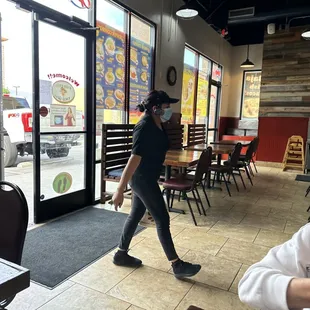  a man walking through a restaurant