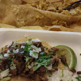 Green Chilaquiles Burrito on top and Carne Asada Taco on the bottom