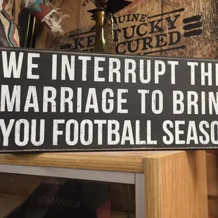 a sign saying we interrupt this marriage to bring you football season