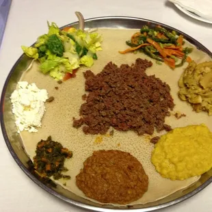 Kitfo and lentils on injera.