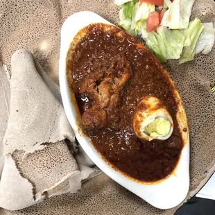 Doro Wot. Traditional dish, chicken stew simmered in berbere sauce and herbal butter served with injera.