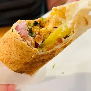 a person holding a burrito