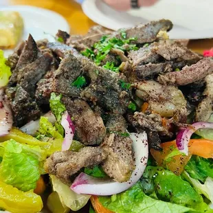 a plate of meat and vegetables