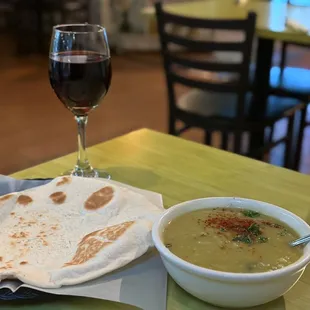 a bowl of soup and a flatbread