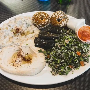 Veggie mazza plate served with hummus, babaganoj, tabouli, 2 falafel and 2 dolma with one pita bread