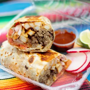 two burritos in a plastic container