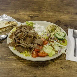 Our Delicious Halal Gyro platter. It come with sliced gyro meat, rice, salad, and hummus w/ pita.