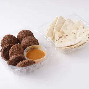 a plastic container with pita chips and dip