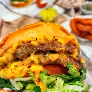 a hamburger with cheese and lettuce
