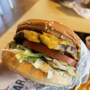 a hand holding a hamburger