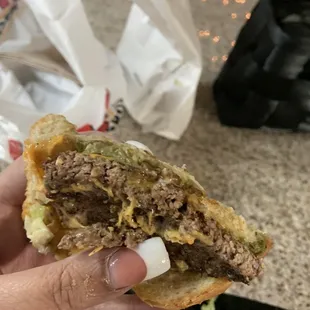 Other half of the sandwich with one patty and a little piece of meat hanging which should&apos;ve been the second patty.