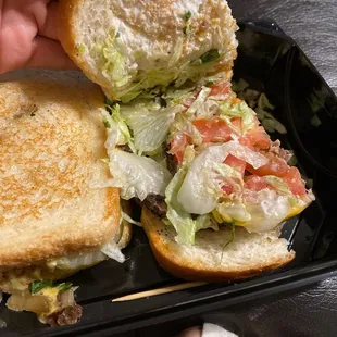 a hand holding a sandwich