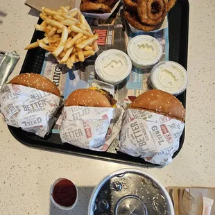 Char burgers, onion rings and fries
