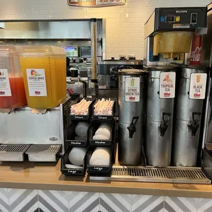 a counter with drinks and juices