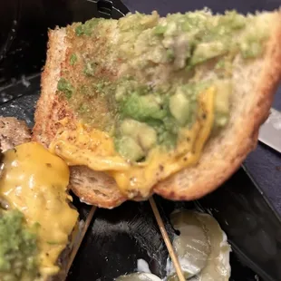 a grilled sandwich with cheese and guacamole