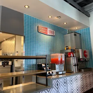 a counter with a drink dispenser