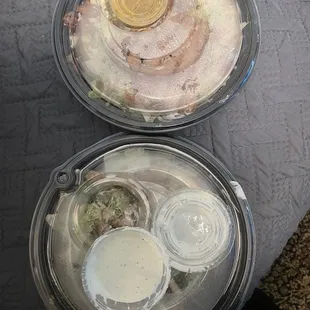 One sealed Cesar salad and an unsealed Cobb salad