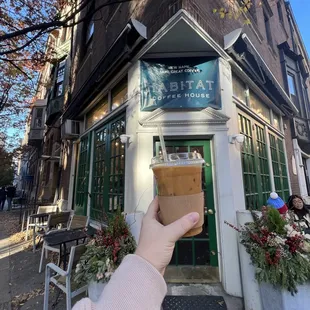 a hand holding a cup of coffee