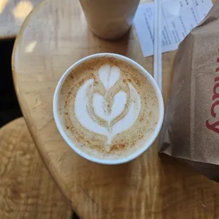 Iced vanilla latte on top, hot vanilla latte with cinnamon on bottom