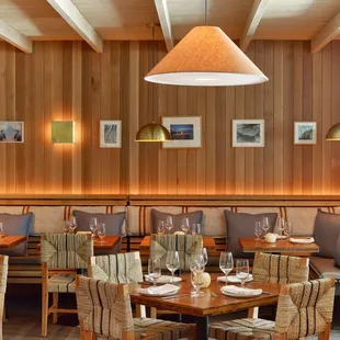 a dining area with wooden paneled walls