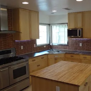 a kitchen with wood cabinets and stainless steel appliances