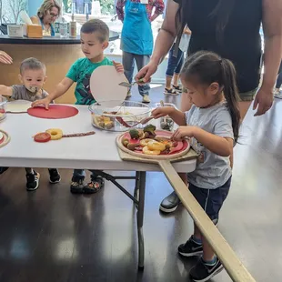 Making pretend pizza at Habitot's pizza kitchen