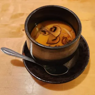 a bowl of soup on a saucer