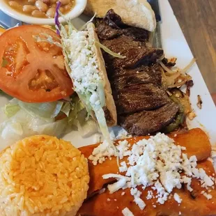 Tampiqueña plate with 2 cheese enchiladas, rice, charro beans, beef taco, steak skirt w/ caramelized onion and side salad.
