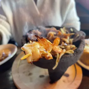 a person holding a piece of food